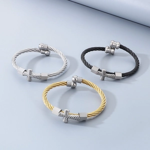 Three-piece metal cable wire bracelet set in silver, gold, and black with cross charm
