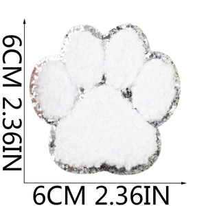 Detail of 6cm white plush cat paw patch with silver sequins and embroidery