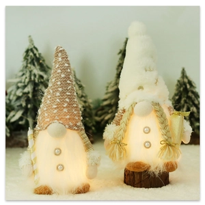 Close-up of glowing plush Christmas gnomes with warm LED lights and sequins on snowy background