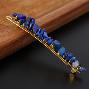 Macro shot of blue raw crystal stones hand-wrapped on a golden metal hairpin