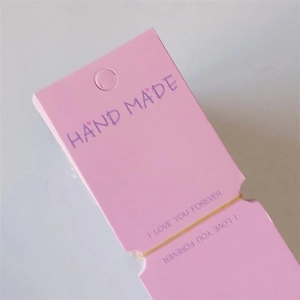 Pink handmade jewelry display cards with hang hole and gold foil lettering for hair clips