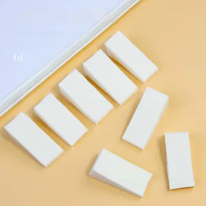 Eight white high-density nail sponges for gradient DIY art on warm yellow background