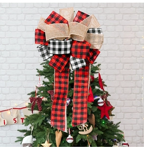 Plaid burlap Christmas tree topper bow with red and black checkered patterns on a tree