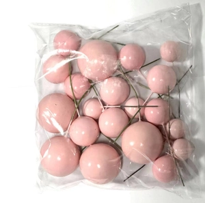 Pink foam cake topper balls with wire stems in various sizes for dessert decoration