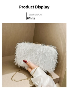 Detailed close-up of a white feather evening clutch bag with elegant golden chain and metal lock