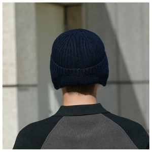 Detail of dark blue ribbed knit beanie with thick thermal lining and cuffed design