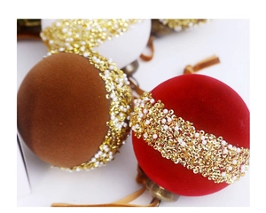 Detail of red and brown velvet Christmas balls with gold sequins and pearl beads