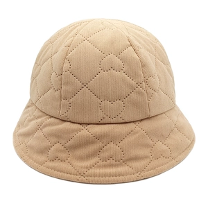 Close-up of heart-shaped quilted pattern on corduroy bucket hat in beige finish