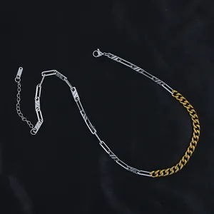 Detail of silver paperclip and golden Cuban link necklace on black textured background