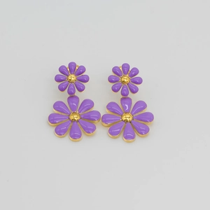 Detail of purple daisy stud earrings with gold accents in high-quality stainless steel