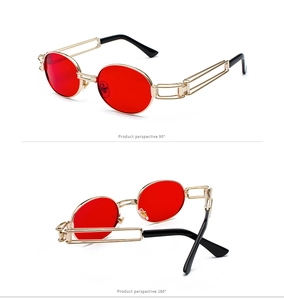 Detailed view of steampunk sunglasses with red oval lenses and gold metal frame details