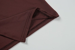 Detail of high-stretch jersey fabric and neat double-needle stitching on dress hem