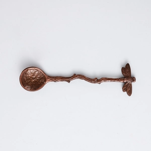 Vintage dragonfly handle coffee spoon with hammered texture on white background