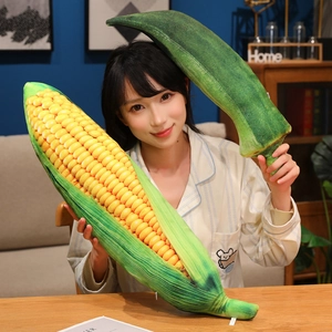 Realistic corn and okra vegetable plush pillows shown by model for home decor