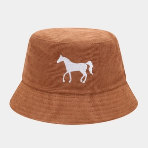 Close-up of caramel bucket hat featuring a white horse embroidery and knit texture