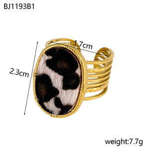 Detail view of a gold leopard print ring with oval pattern inlay and multi-layered band