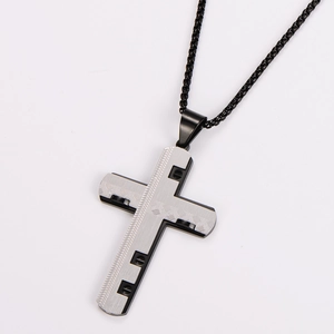 Detailed close-up of textured silver cross pendant with black frame and box chain