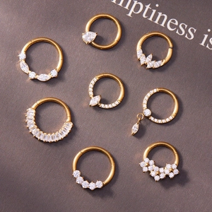 Set of 8 gold titanium piercing rings with clear 5A zircons in various geometric shapes