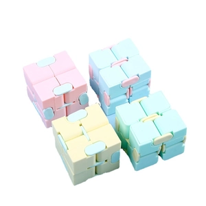 Set of four pastel infinity cubes for stress relief in pink, blue, beige, and mint colors