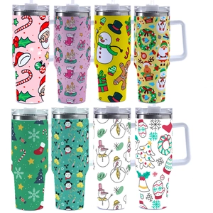 Close-up of 40oz stainless steel tumblers with festive Santa and snowman Christmas patterns