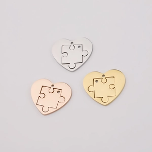 Detailed close-up of heart puzzle pendants in silver, gold and rose gold finishes