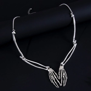 Detailed view of silver skeleton hand necklace with vintage alloy bone texture