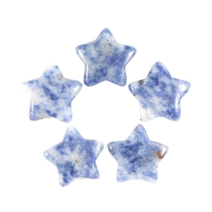 Macro shot of five star-shaped blue and white sodalite stones with smooth polished texture