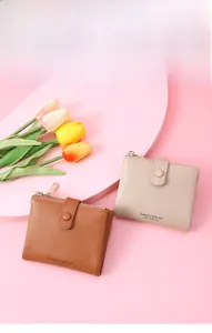 Close-up of short bifold PU leather wallet with pebbled texture and metal zipper detail