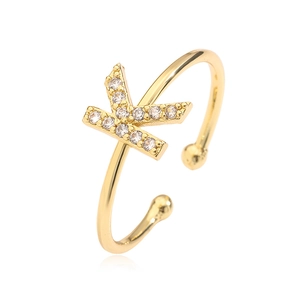 Detail of adjustable gold ring featuring a cubic zirconia letter K and spherical ends