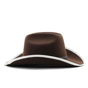 Detail of dark brown wool felt cowboy hat with white piped brim and black thin band