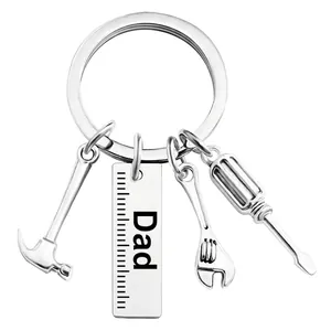 Detail of metal Dad keychain featuring miniature hammer, wrench, and screwdriver tools