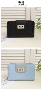 Detail of crocodile pattern long wallets in black and blue with gold metal twist locks