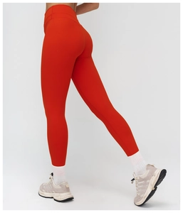 Detail view of high-waist red yoga pants with seamless butt-lifting and matte fabric texture