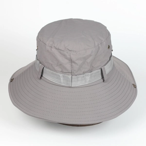 Detail of grey outdoor sun hat with wide brim, metal vents, and reinforced stitching