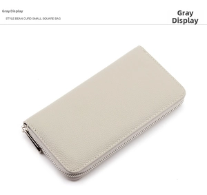 Detail of light grey pebbled leather long wallet with silver zipper and neat stitching
