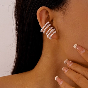 French style multi-layered pearl ear cuff clip-on earring worn on model's ear