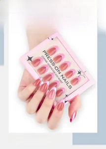 Macro detail of nude pink French tip press-on nails in oval shape with packaging box