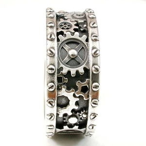 Macro shot of steampunk gear engravings on a vintage silver mechanical ring for men