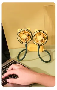 Close-up of flexible neck fan used as desktop fan next to laptop in warm office setting