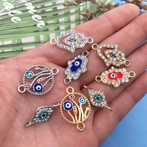 Macro shot of Hamsa Hand and Evil Eye alloy charms for DIY jewelry making