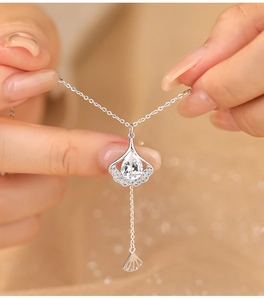 Detailed close-up of S925 sterling silver ginkgo leaf pendant with sparkling zircon stone