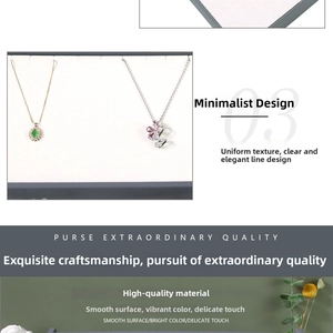 Detailed close-up of gold emerald pendant and silver floral necklace with gemstones