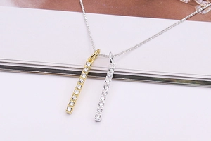 Detailed view of rectangular micro-pave zircon pendants in gold and silver S925 finishes