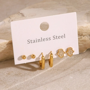 Set aus drei Paar goldenen Edelstahlohrringen mit Hamsa-Hand und minimalistischen Steckern