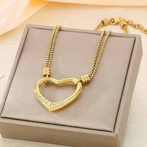 Detail of a hollow heart pendant necklace with rhinestones and double-strand mesh chain