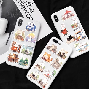 Close-up of cute hand-drawn animal graffiti stickers on white smartphone cases