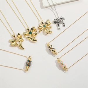 Bow zircon pendant and colorful enamel cylinder choker necklaces on white background