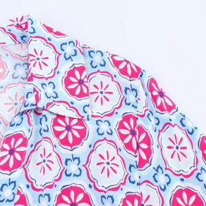 Close-up of V-neck shirt dress collar with blue and pink geometric floral pattern