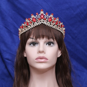 Elegant gold bridal tiara with red gemstones and crystals on a female model