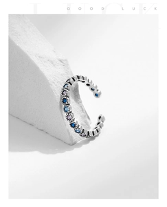 Detail of vintage 925 silver ring with blue and purple gemstones on stone background
